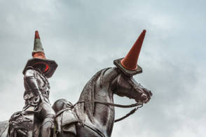 Duke of Wellington statue in Glasgow, there are orange traffic cones on the head of the man and the horse